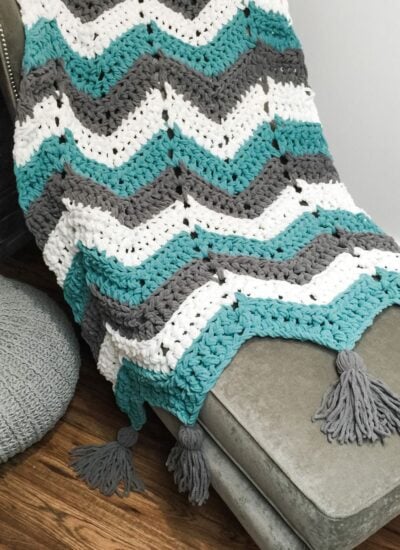 Chevron throw with tassels on a chair.