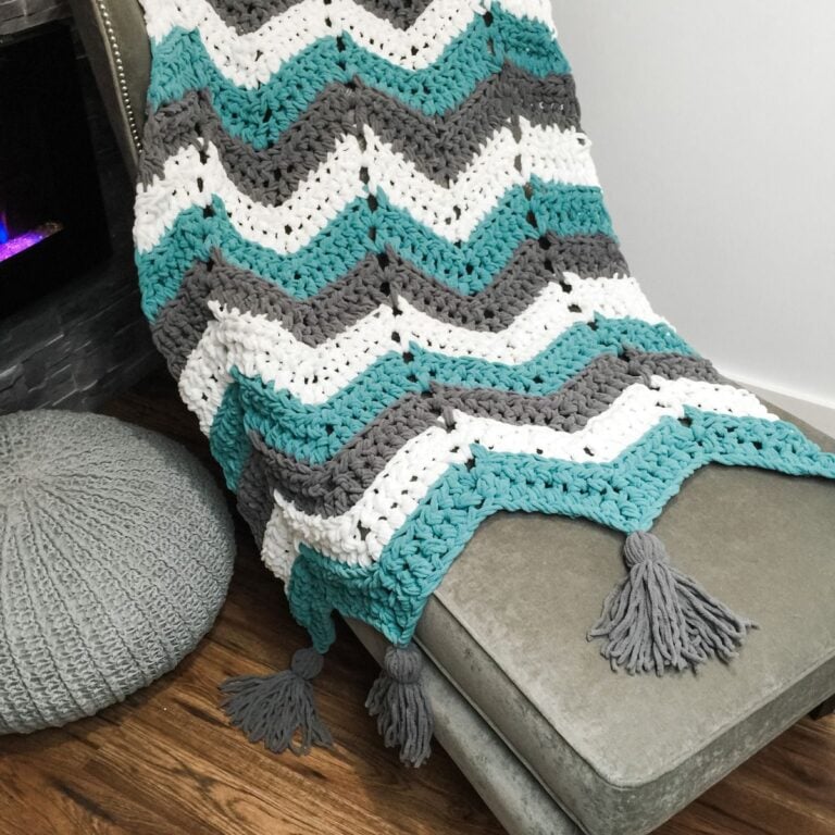 Chevron throw with tassels on a chair.