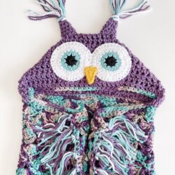 A crocheted owl hoodie with tassels.