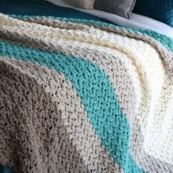 A King Size Farmhouse Blanket on top of a bed.