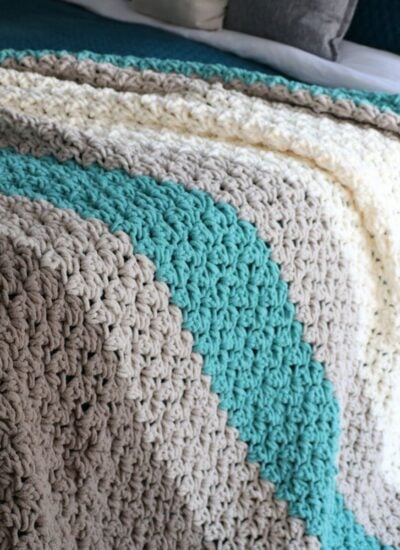 A King Size Farmhouse Blanket on top of a bed.