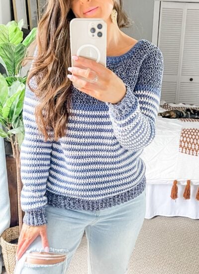 A woman taking a selfie in ripped jeans and a blue striped sweater, rocking the Piece of Cake Cardi.