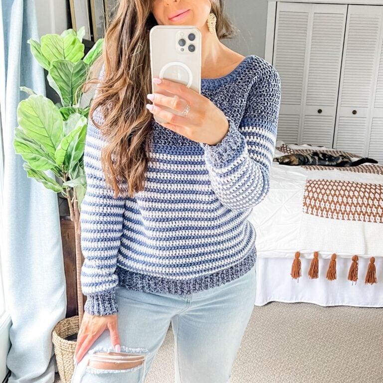 A woman taking a selfie in ripped jeans and a blue striped sweater, rocking the Piece of Cake Cardi.