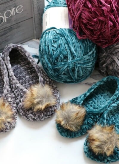 Crochet velvet slippers with pom poms.