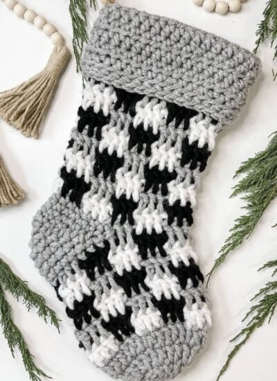 Crochet farmhouse Christmas stocking pattern in houndstooth.