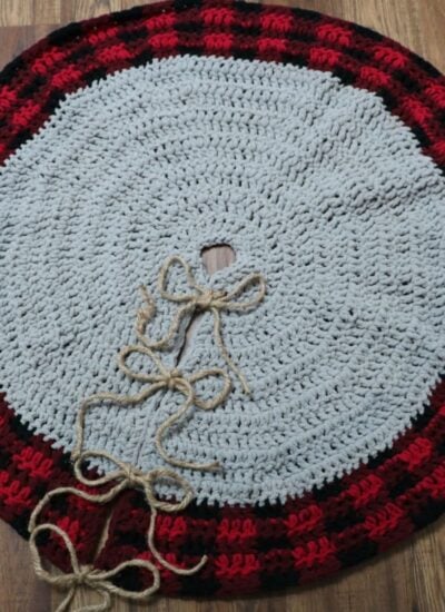 A red and black buffalo plaid crocheted Christmas tree skirt.
