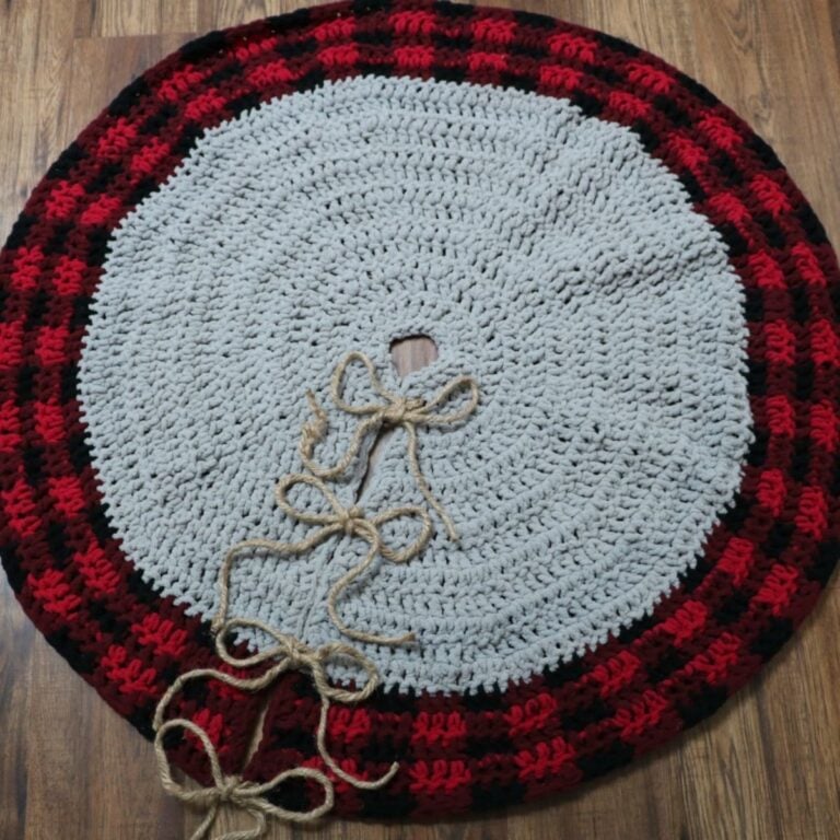 A red and black buffalo plaid crocheted Christmas tree skirt.