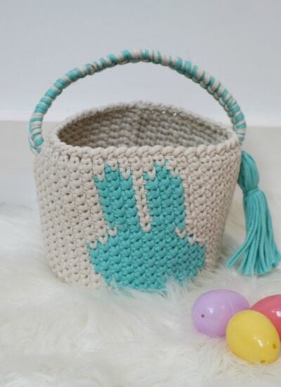 A crocheted bunny easter basket with eggs.