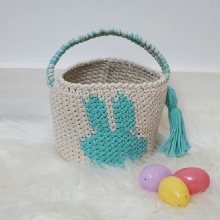 A crocheted bunny easter basket with eggs.