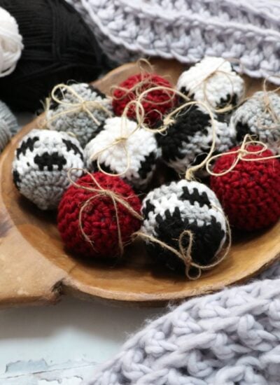 Crocheted Christmas ornaments in a wooden bowl.