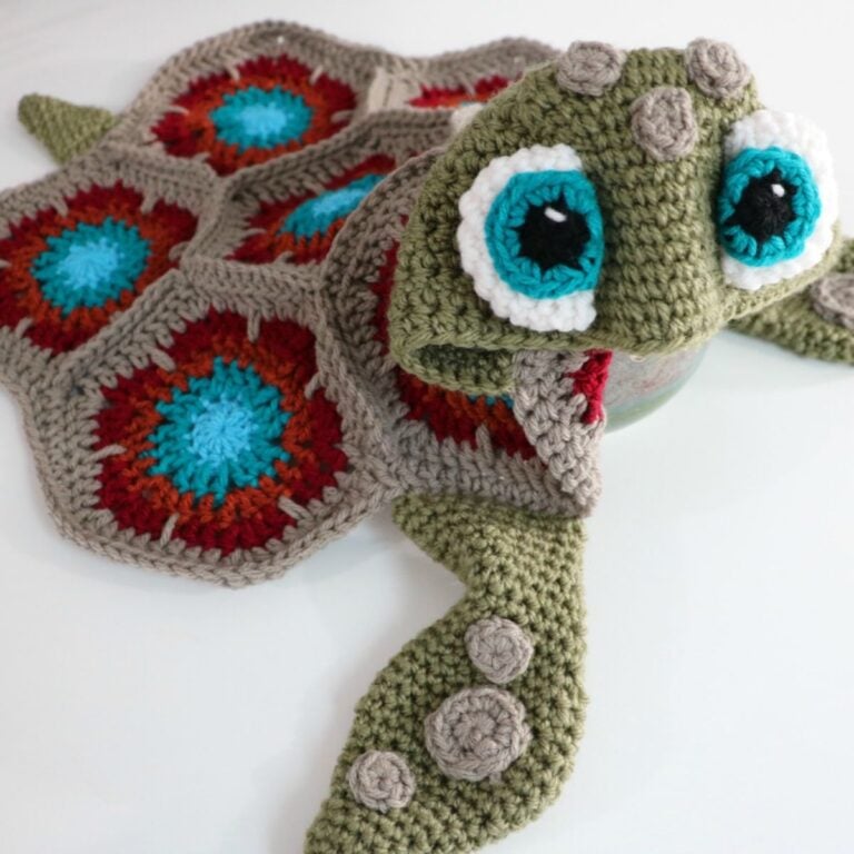 A crocheted turtle hat and mittens transformed into a Hooded Sea Turtle Blanket.