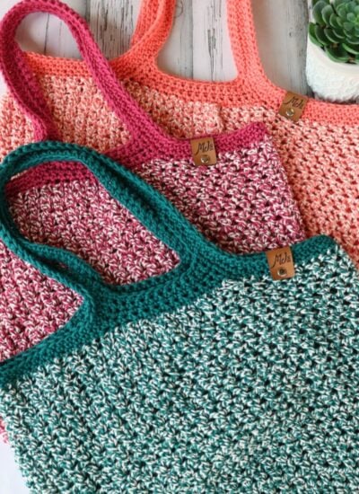 Three Dishie-lous Market Bags on a wooden table.