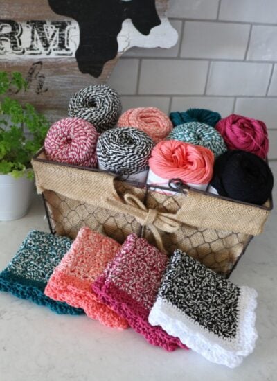 A basket full of colorful Rosy Posy dishcloths and a sign that says farm.