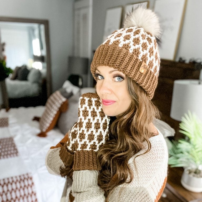 A woman wearing a brown and white knit hat and Mosaic Crochet mittens.