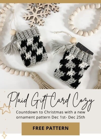 A plaid gift card cozy with stars and tassels.