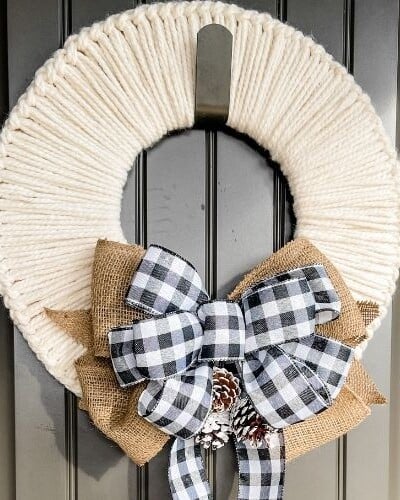 A holiday wreath hanging on a door.