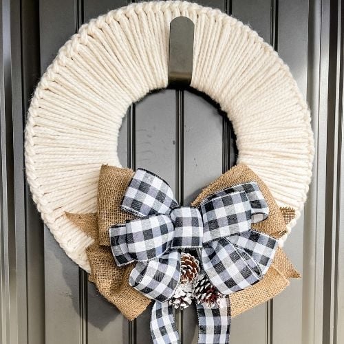 A holiday wreath hanging on a door.