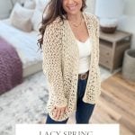 Woman wearing a Crochet Lacy Spring Cardigan over a white top and jeans, standing in a softly lit bedroom. Text reads: "Lacy Spring Cardigan: Crochet Pattern & Video, 2 Piece Construction.