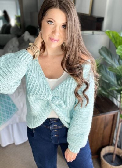 A woman wearing a blue sweater.