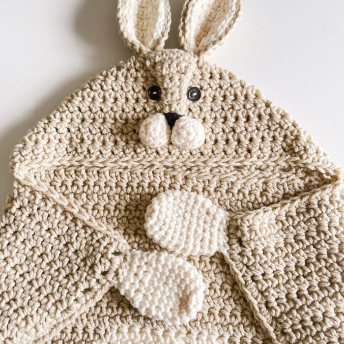Crochet Hooded Rabbit Blanket displayed on a white surface.