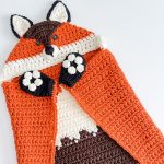 Crochet pattern for a cozy hooded fox blanket, with the added bonus of a free video tutorial.