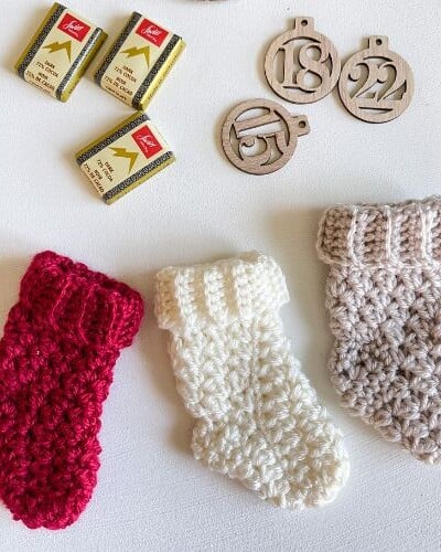 A set of mini crochet stockings and a box of chocolates.