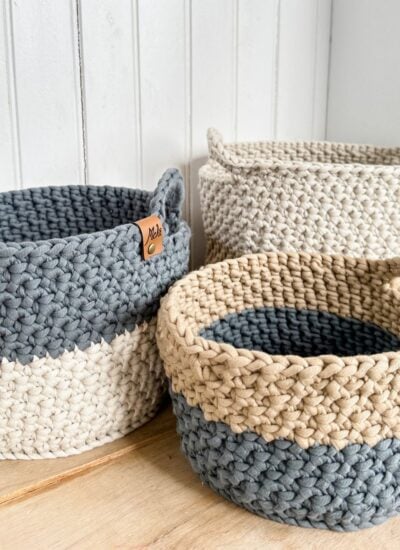 Three Crocheted Baskets on a Wooden Table.