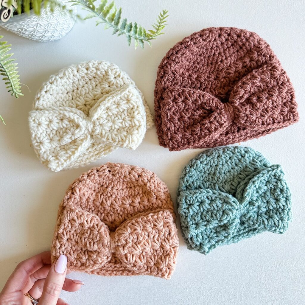 Four crocheted beanie hats, including a Star Stitch Crochet Baby Hat, in different colors.