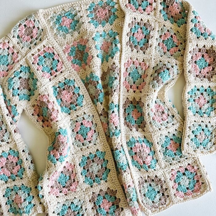 A Granny Square Cardigan with pink and blue flowers.