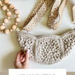 Hand holding a chic crochet crossbody bag with a geometric strap, wooden beads, and decorative balls nearby. Text reads: "Granny Style Crossbody Bag: Crochet Pattern & Video Tutorial.