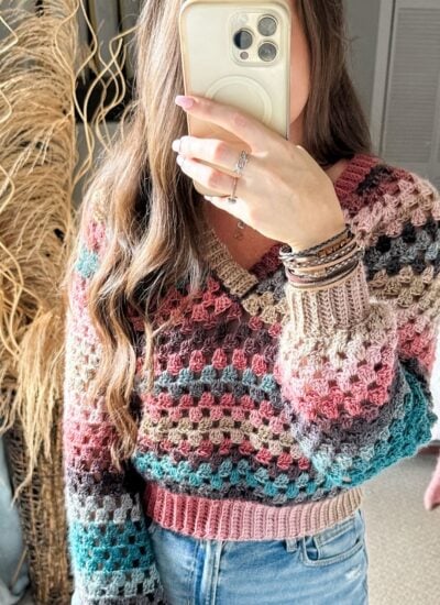 A woman in a V-Neck Crochet Sweater taking a selfie.