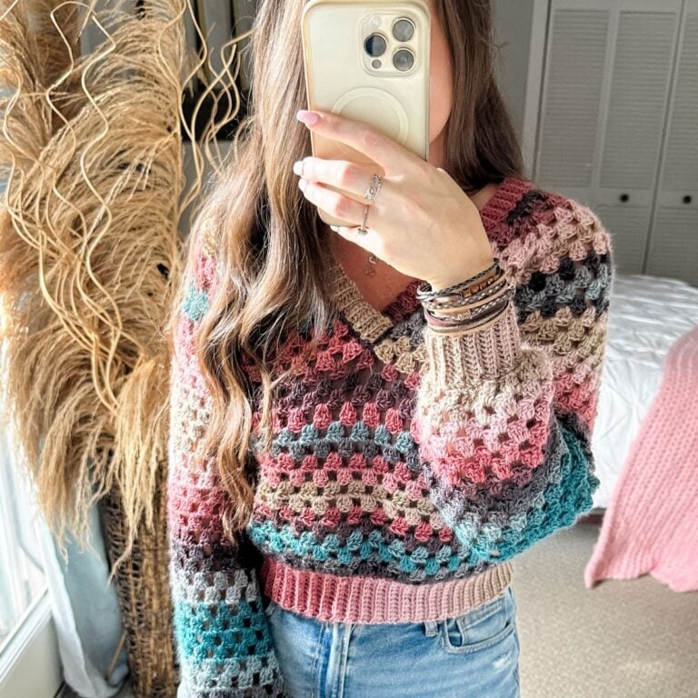 A woman in a V-Neck Crochet Sweater taking a selfie.