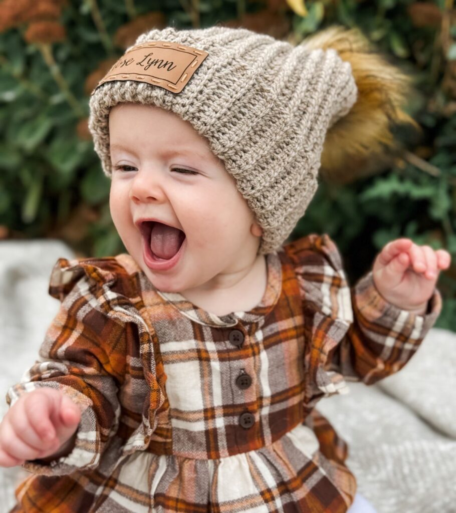 A baby wearing a knit beanie.