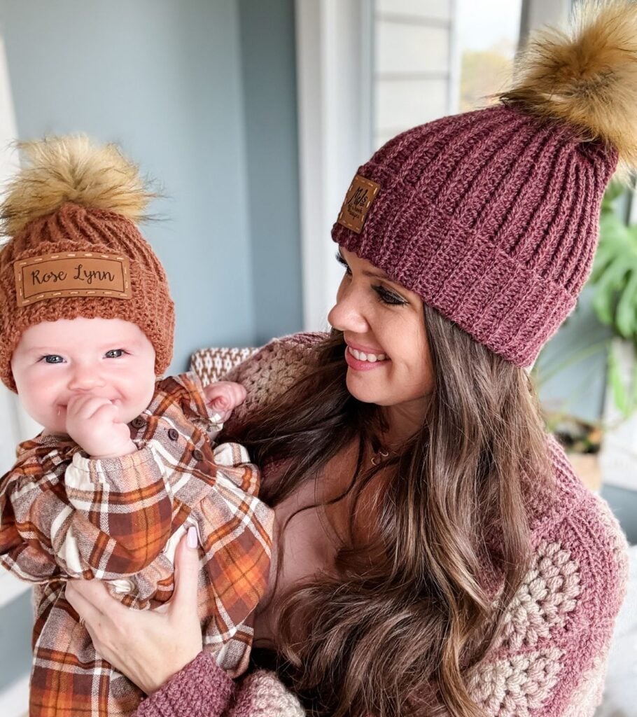 A woman holding a baby wearing a Rocky Ridge Crochet Hat.