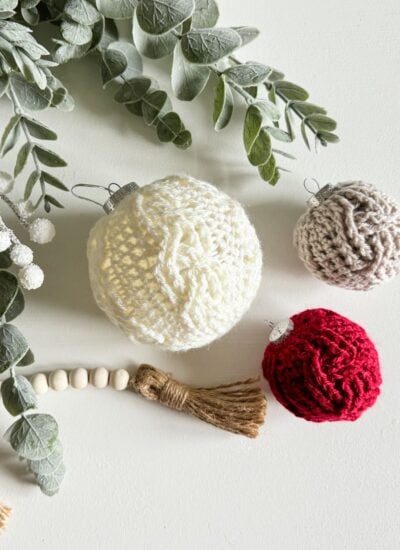 Crocheted Christmas ornaments with eucalyptus leaves.