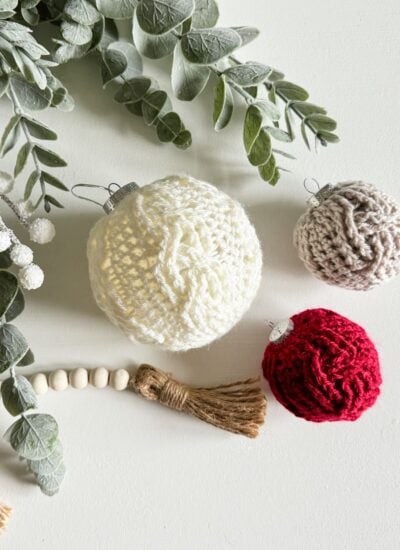 Crocheted Christmas ornaments with eucalyptus leaves.