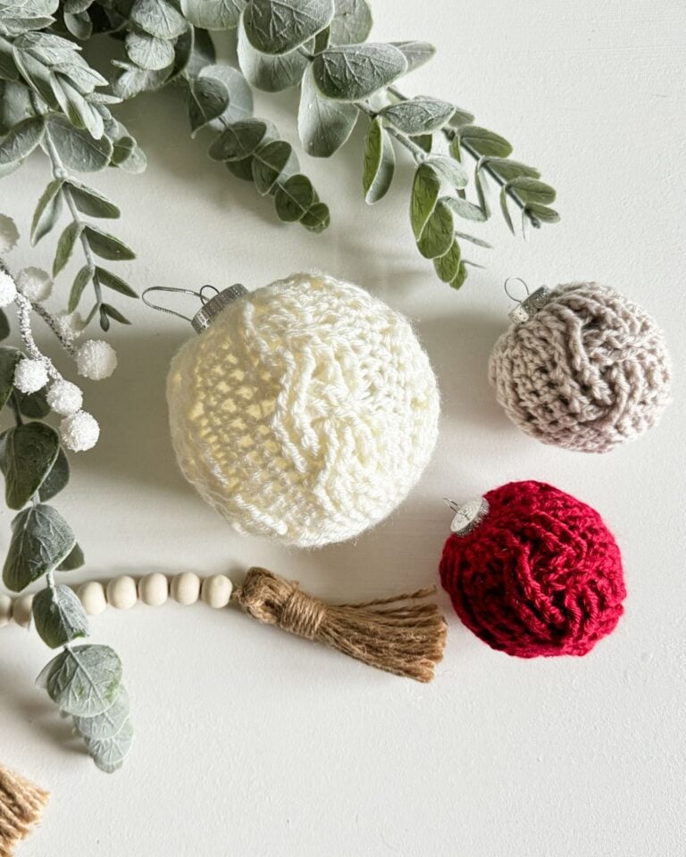 Crocheted Christmas ornaments with eucalyptus leaves.
