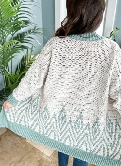 The back view of a woman wearing a knit cardigan.