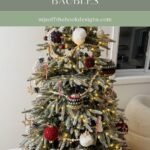 A decorated Christmas tree with crocheted baubles, Granny square ornaments, candy canes, string lights, and festive decorations in a cozy living room.