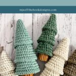 Five crocheted tiered trees in various shades of green and cream, each with a cinnamon stick as the trunk, evoke the charm of a granny square ornament, displayed on a white wooden surface.