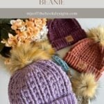 Four knitted beanies with faux fur pom-poms in purple, orange, maroon, and gray are displayed near a bouquet of flowers and a charming granny square ornament. Text reads: "Snuggle Season Beanie" and website link.