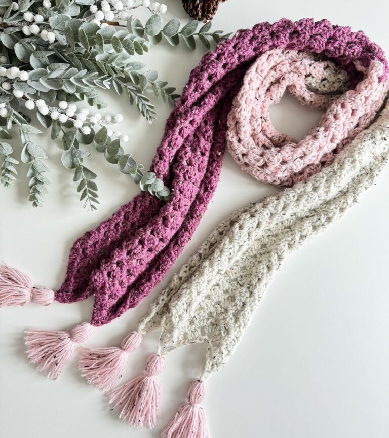 Two Granny Stitch scarves with tassels on them.