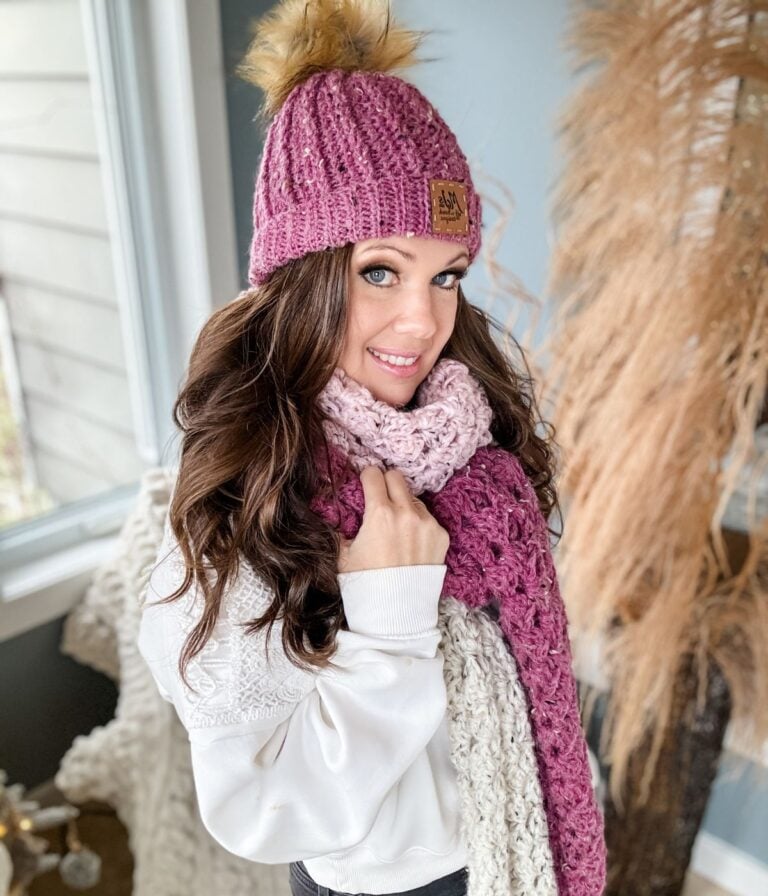 A woman wearing a crochet hat and scarf.