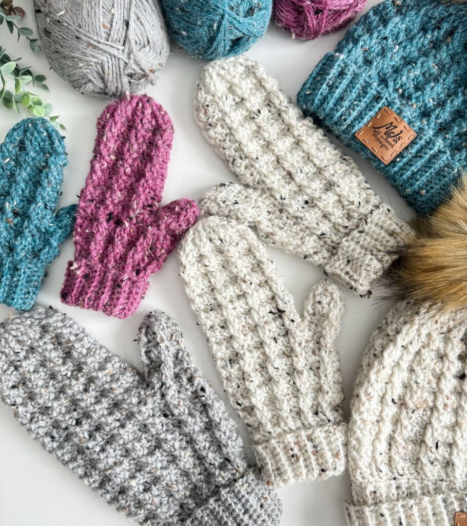 Crocheted mittens showcased on a white surface.