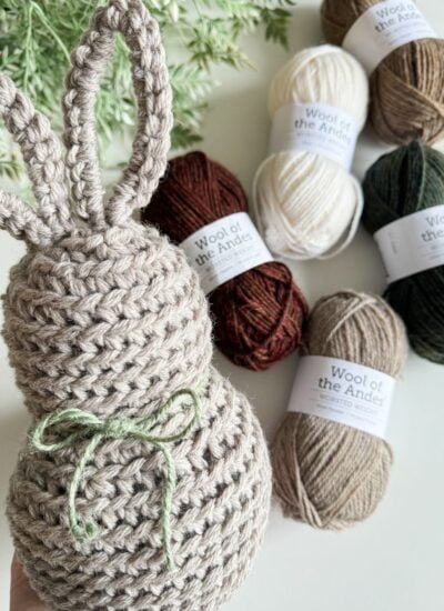 A crochet bunny with yarn next to it.