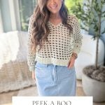 A woman in a crochet mesh V-neck sweater and denim skirt stands indoors. Text reads: "Peek A Boo V-Neck, Crochet Pattern & Video, Sizes XS-5X.