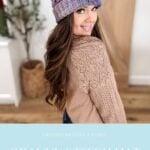 A woman wearing a crocheted Granny Stitch Hat in purple and blue with pom-poms and a beige sweater stands indoors, smiling over her shoulder. Text reads: "Granny Stitch Hat, mjsoffthehookdesigns.com".