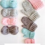 Four pairs of crocheted mittens in various colors are displayed beside matching yarn balls; text below reads "Heavenly Herringbone Mittens Crochet Pattern & Video—perfect companions for your next Snowy Season Sweater project.