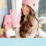 A woman wearing a pink knit hat and matching pink mittens poses indoors, smiling. Text below advertises a crochet pattern and video for "Heavenly Herringbone Mittens" and the cozy Snowy Season Sweater.