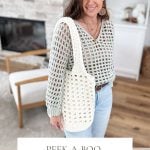 Woman in a crochet top and jeans holds a white crochet mesh market bag. She's in a cozy living room with a fireplace. Text reads: "Peek-a-boo Market Bag, Crochet Pattern & Video, Bulky, Quick & Easy".